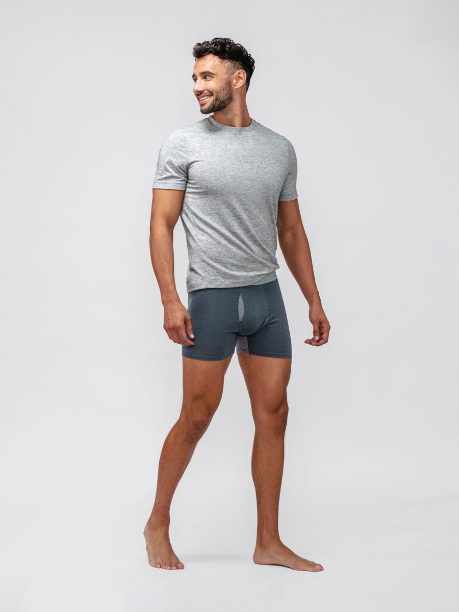 model wearing deep indigo composite merino boxer brief and grey composite merino tee facing forward and looking off camera