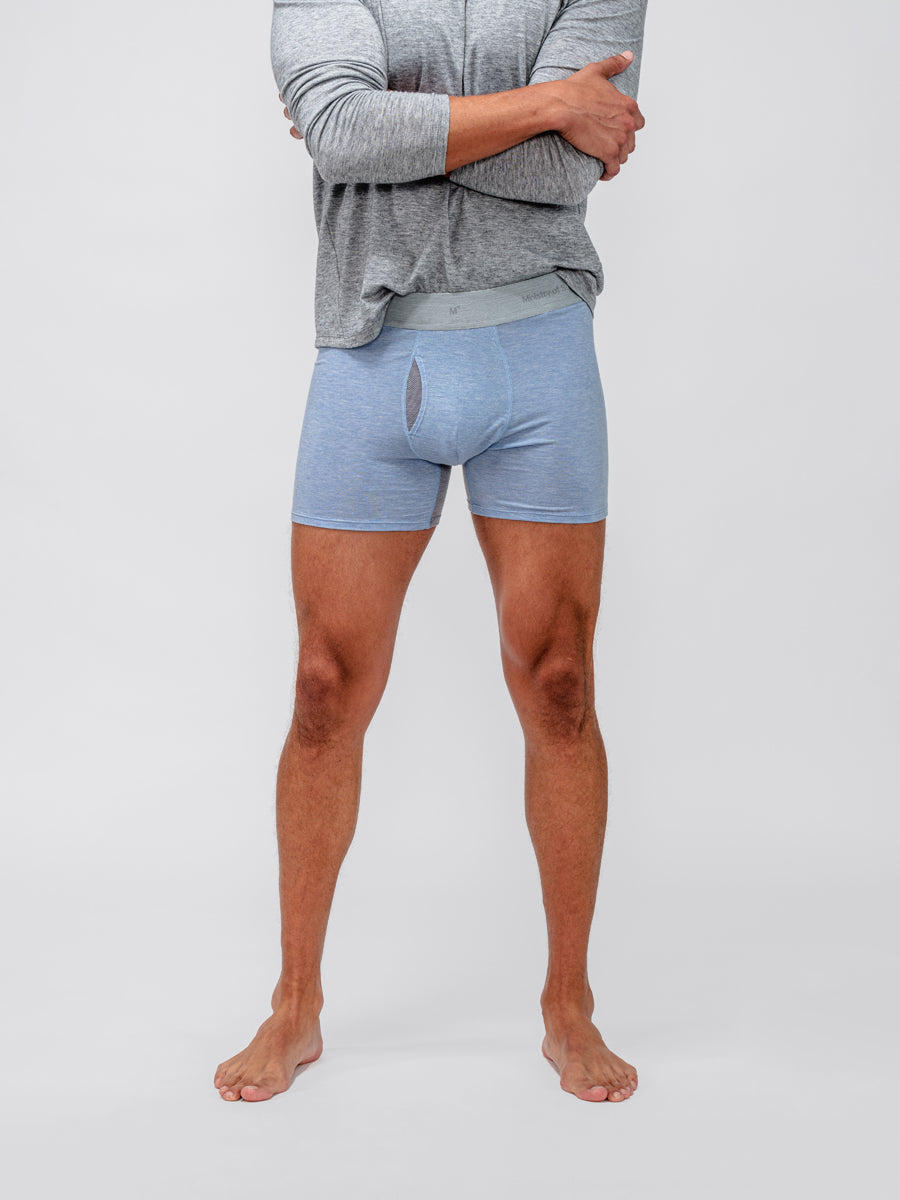 model wearing men's light blue heather composite merino boxer brief and grey composite merino long sleeve tee close up of front