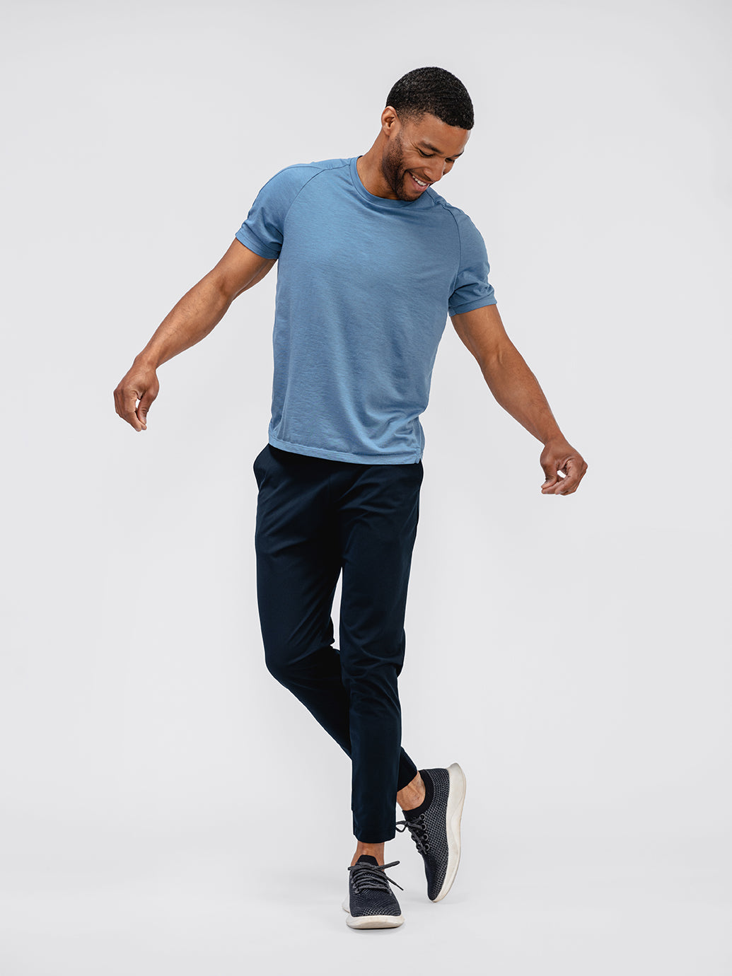 model wearing mens kinetic jogger navy and mens composite merino stone blue standing legs cropped