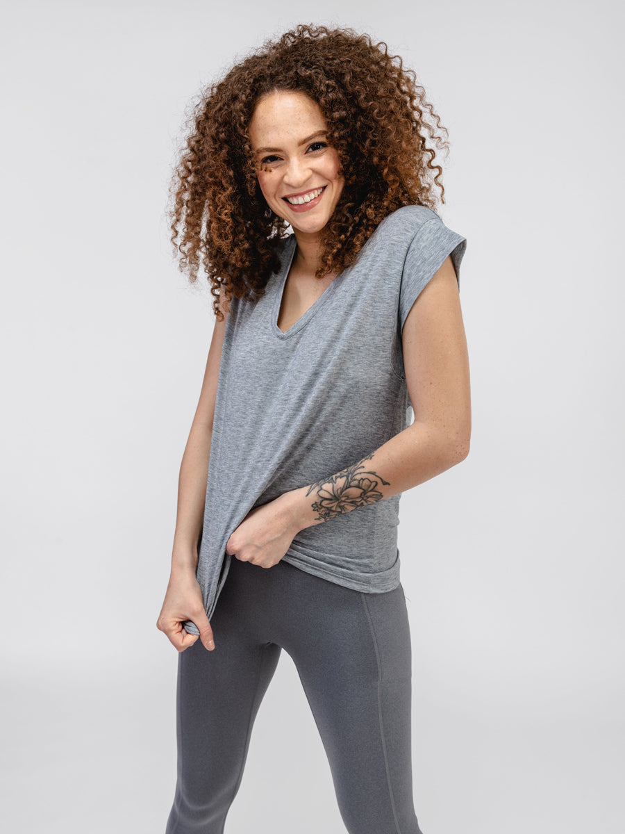 Women's Pale Grey Heather Composite Merino V-Neck Tee on model stretching fabric