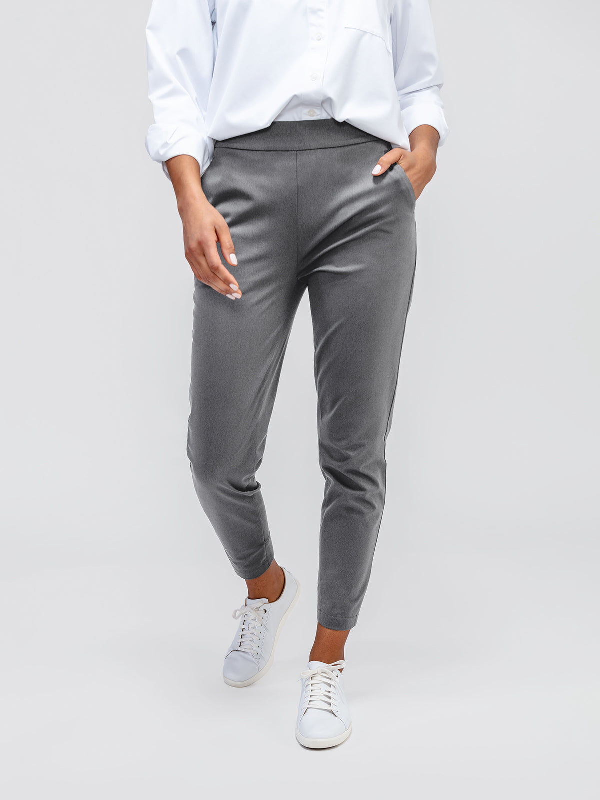 Women's Charcoal Kinetic Pull on Pant on model walking forward with hand in pocket