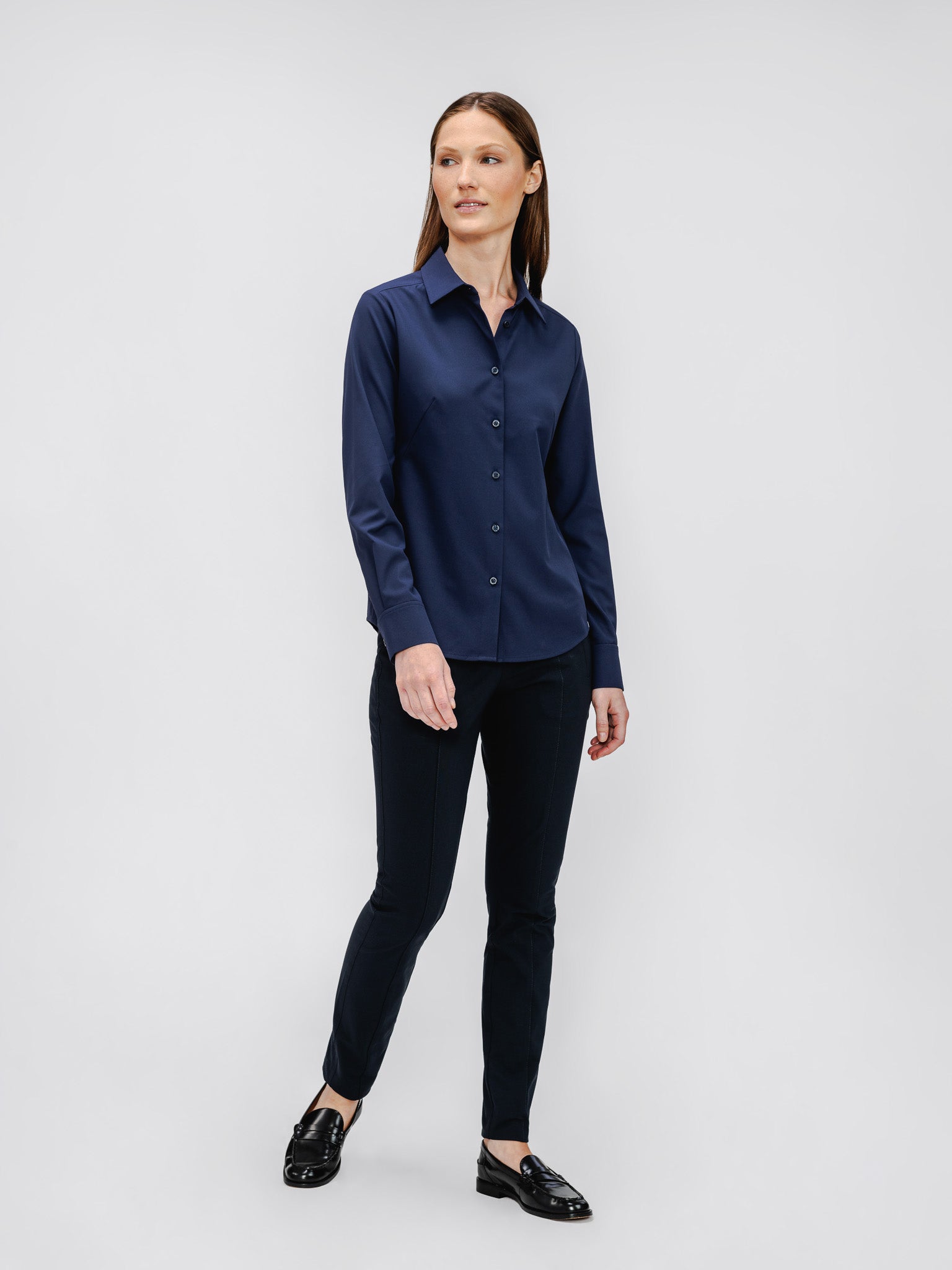 model wearing womens pintuck pant navy and womens aero zero classic shirt navy in studio