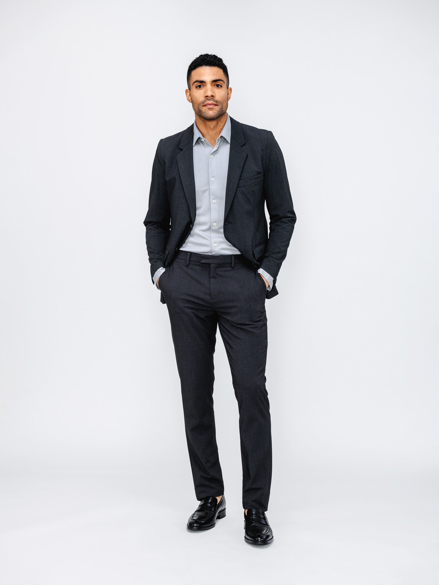 Men's Dark Charcoal Velocity Suit on model with hands in pant pockets