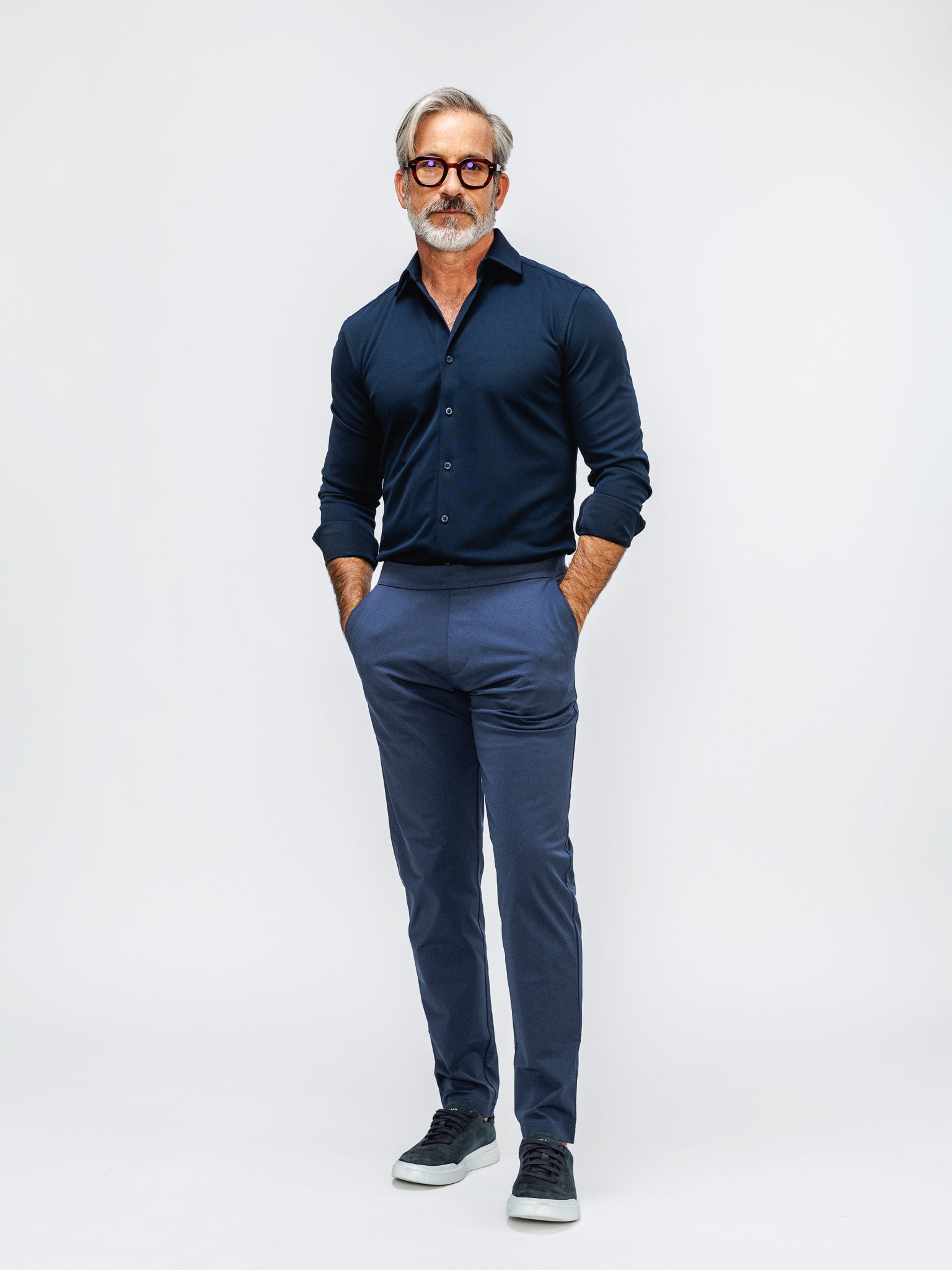 model wearing mens apollo dress shirt navy and mens kinetic pull on pant shadow blue heather on model in studio